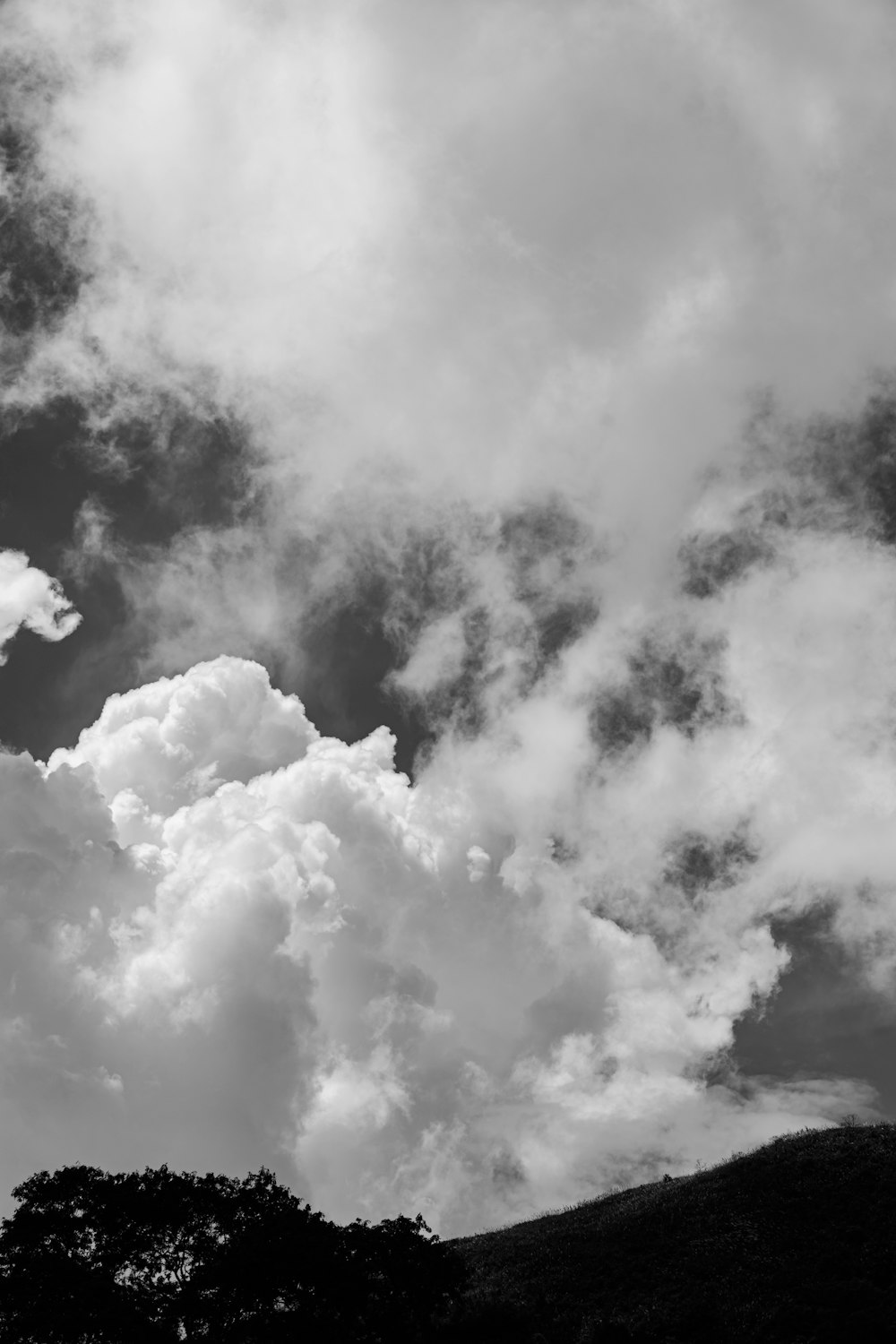 a black and white photo of clouds in the sky