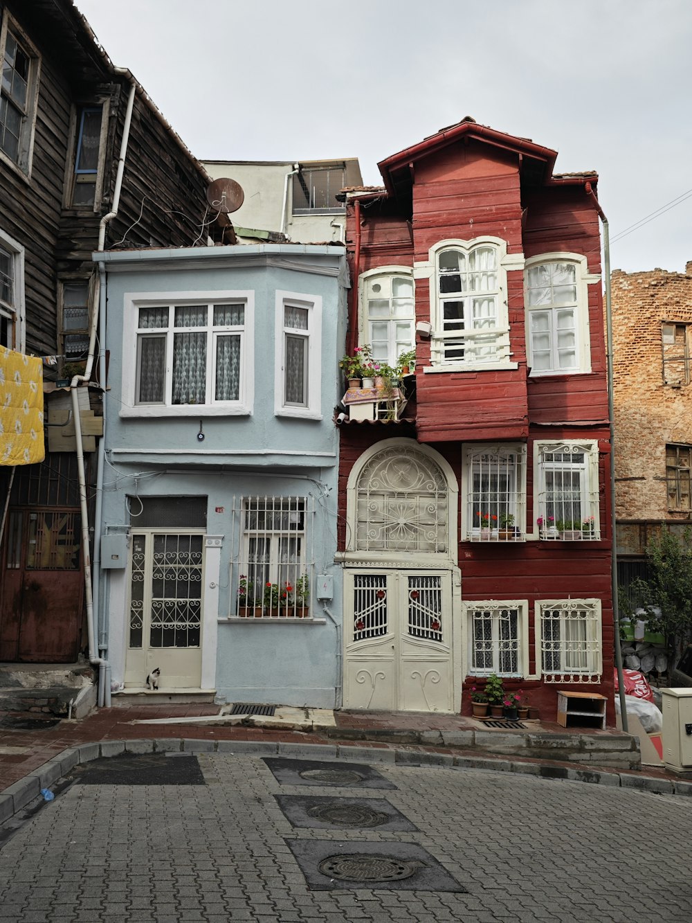 a row of colorful houses on a cobblestone street