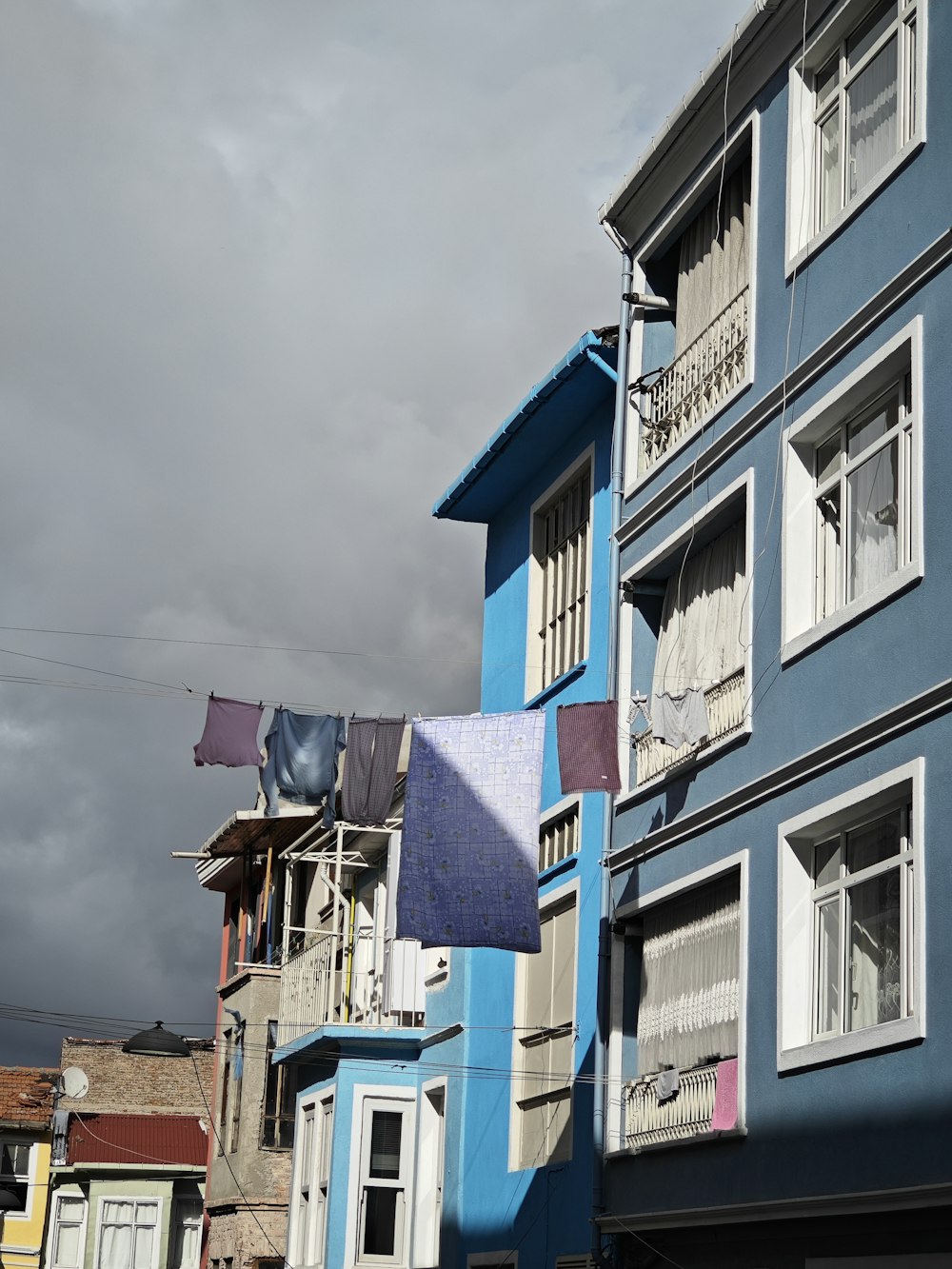 a row of colorful houses on a cloudy day
