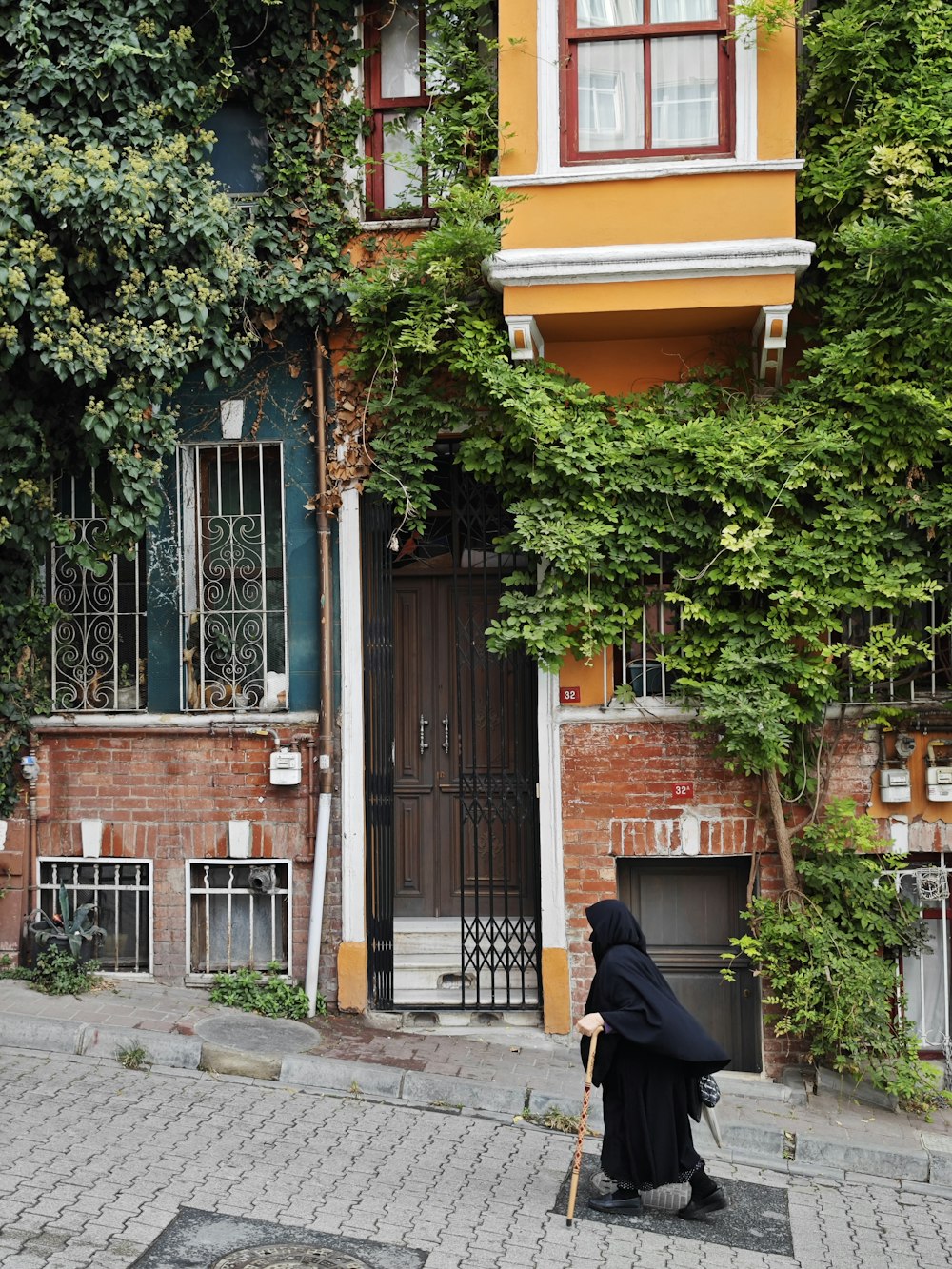 a nun walking down a street in front of a building