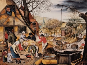 A bustling village scene featuring people engaged in various activities such as preparing food, carrying barrels, and working outside their homes. The village has rustic houses with thatched roofs, and vibrant trees line the path running through the settlement. In the foreground, several figures are preparing a large pig for cooking, while children and other adults observe and assist.