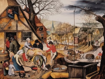 A bustling village scene featuring people engaged in various activities such as preparing food, carrying barrels, and working outside their homes. The village has rustic houses with thatched roofs, and vibrant trees line the path running through the settlement. In the foreground, several figures are preparing a large pig for cooking, while children and other adults observe and assist.