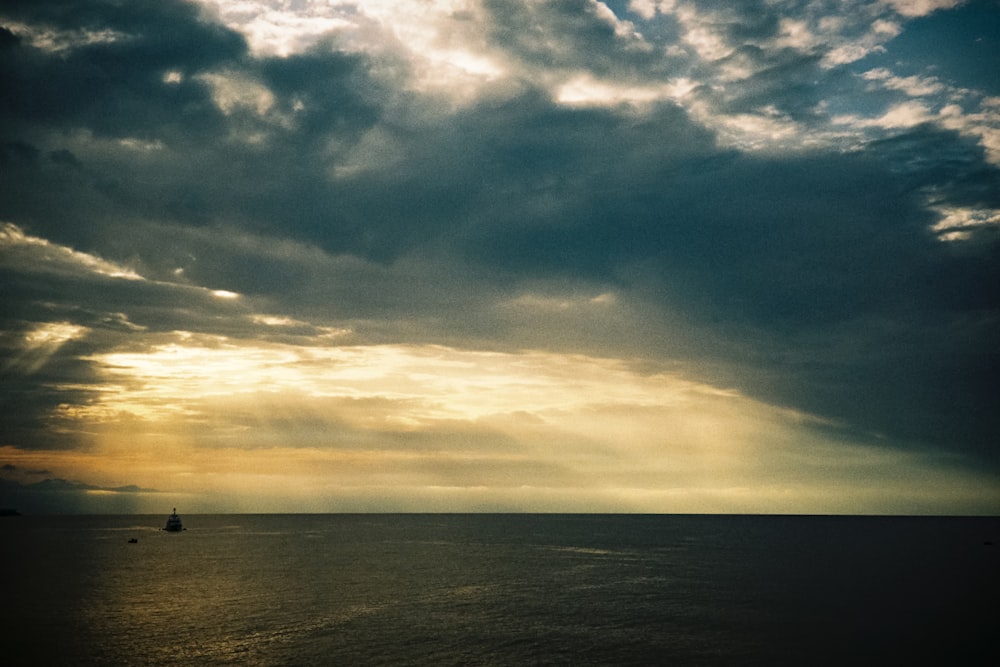 a large body of water under a cloudy sky