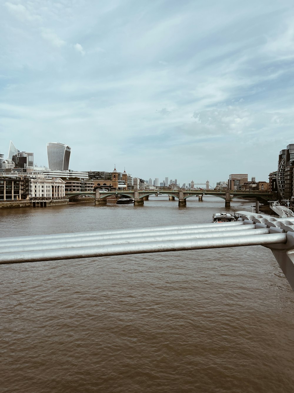 a view of a bridge over a river with a city in the background