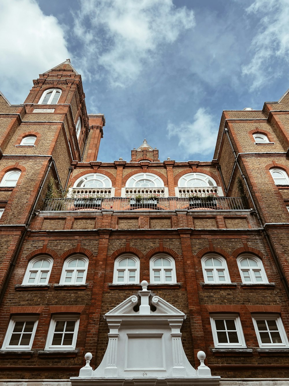 a tall brick building with a clock on the front of it