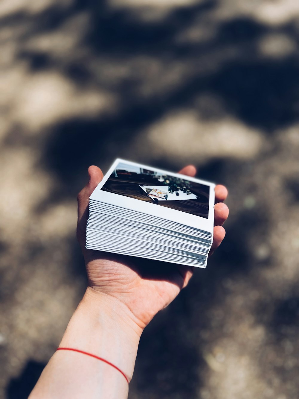 a person holding a stack of cards in their hand
