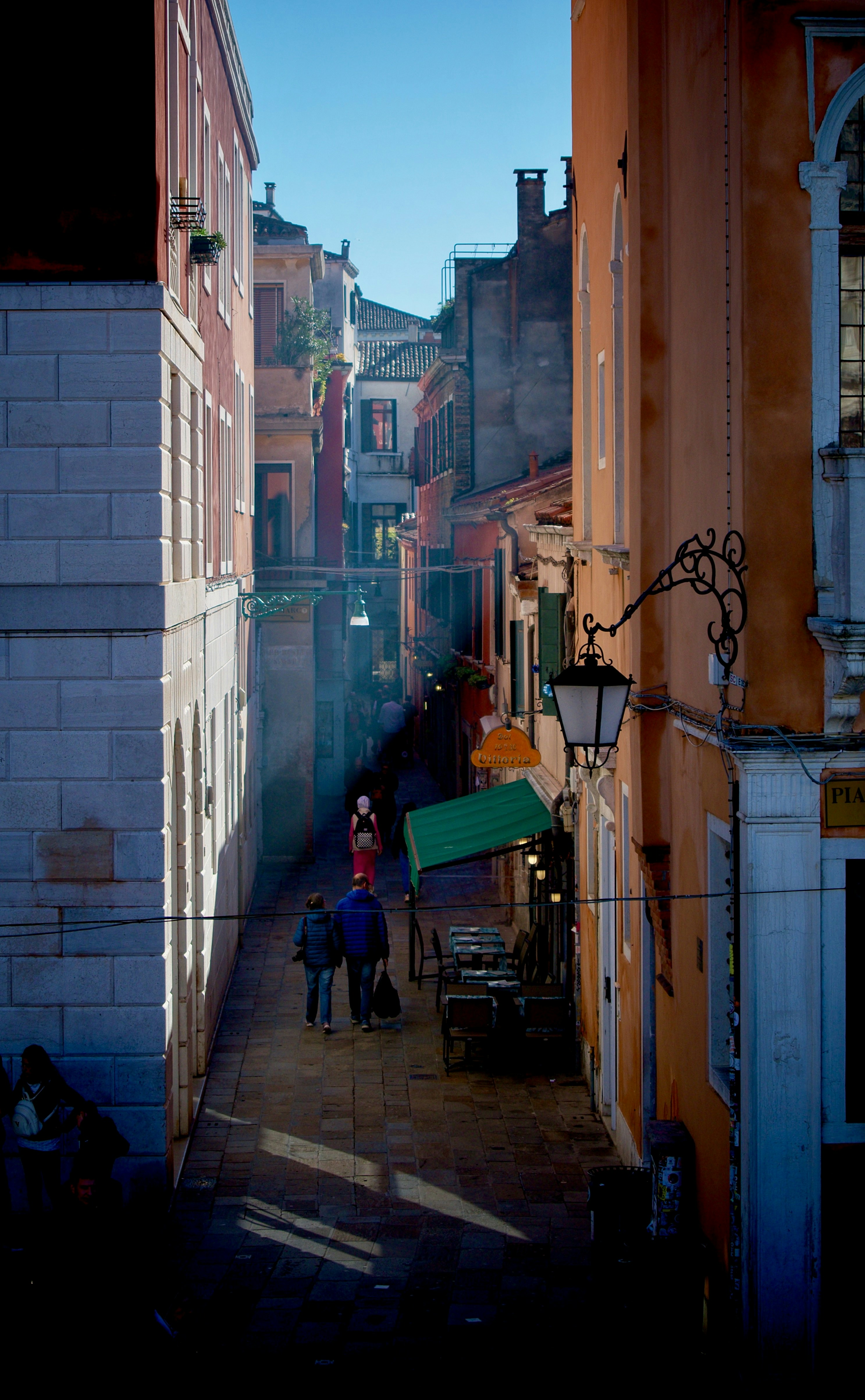 a couple of people that are walking down a street