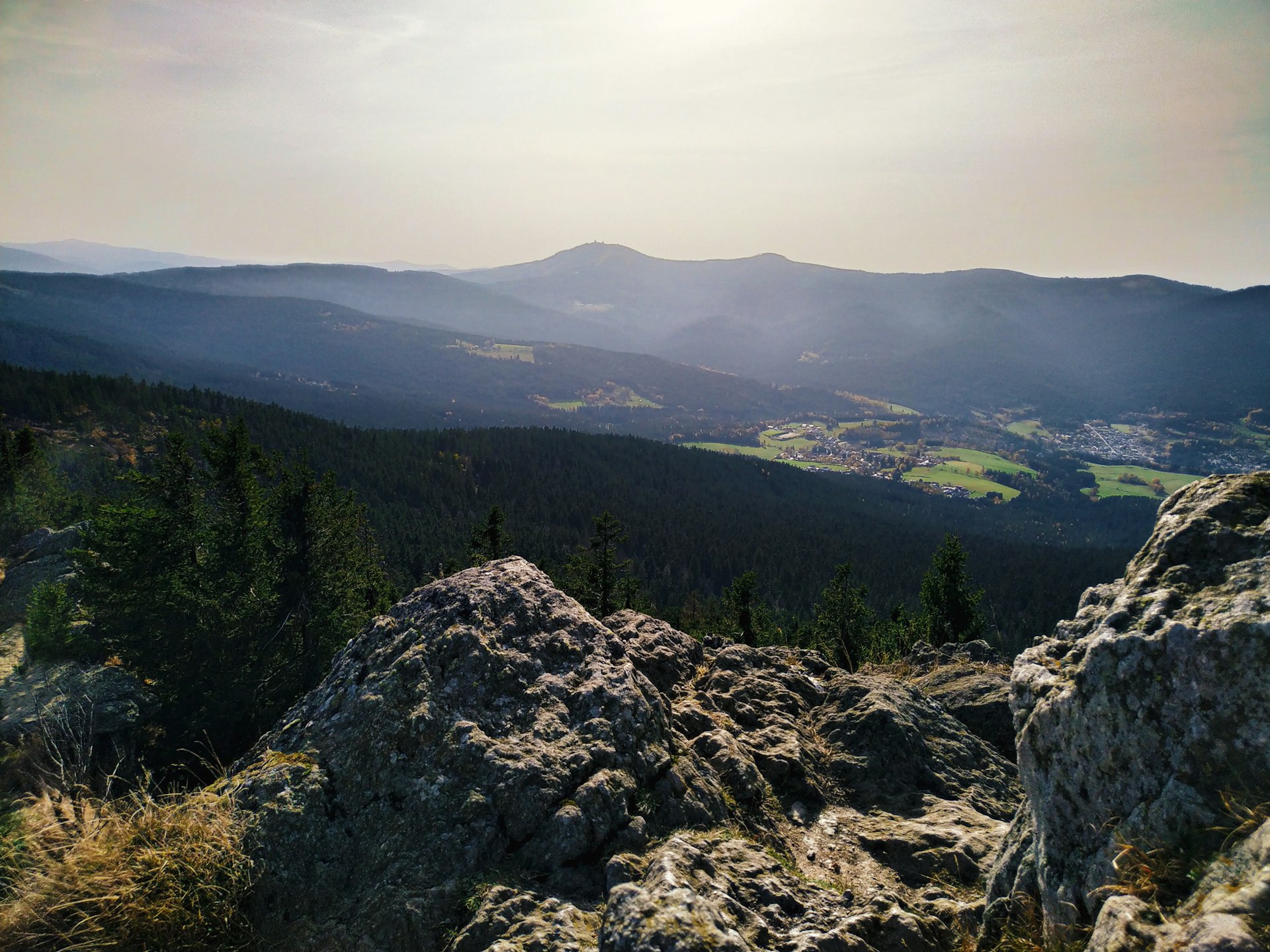 a view of a valley and mountains from the top of a mountain