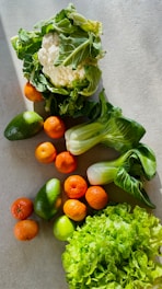 a table topped with lettuce, carrots and other vegetables