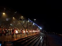 Pilgrims gathered at the vibrant Ganga Aarti ceremony, lights flickering against the night sky.