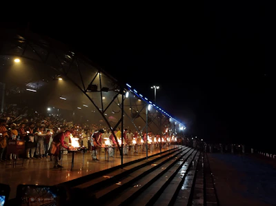 Pilgrims gathered at the vibrant Ganga Aarti ceremony, lights flickering against the night sky.