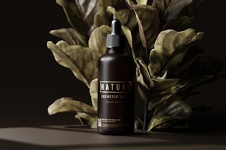 a bottle of tanning lotion next to a plant