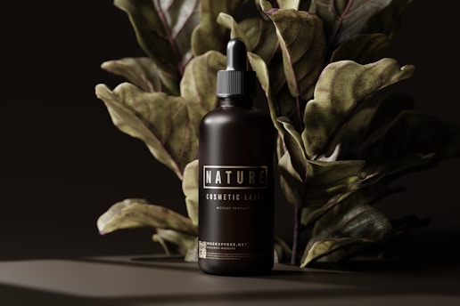 a bottle of tanning lotion next to a plant