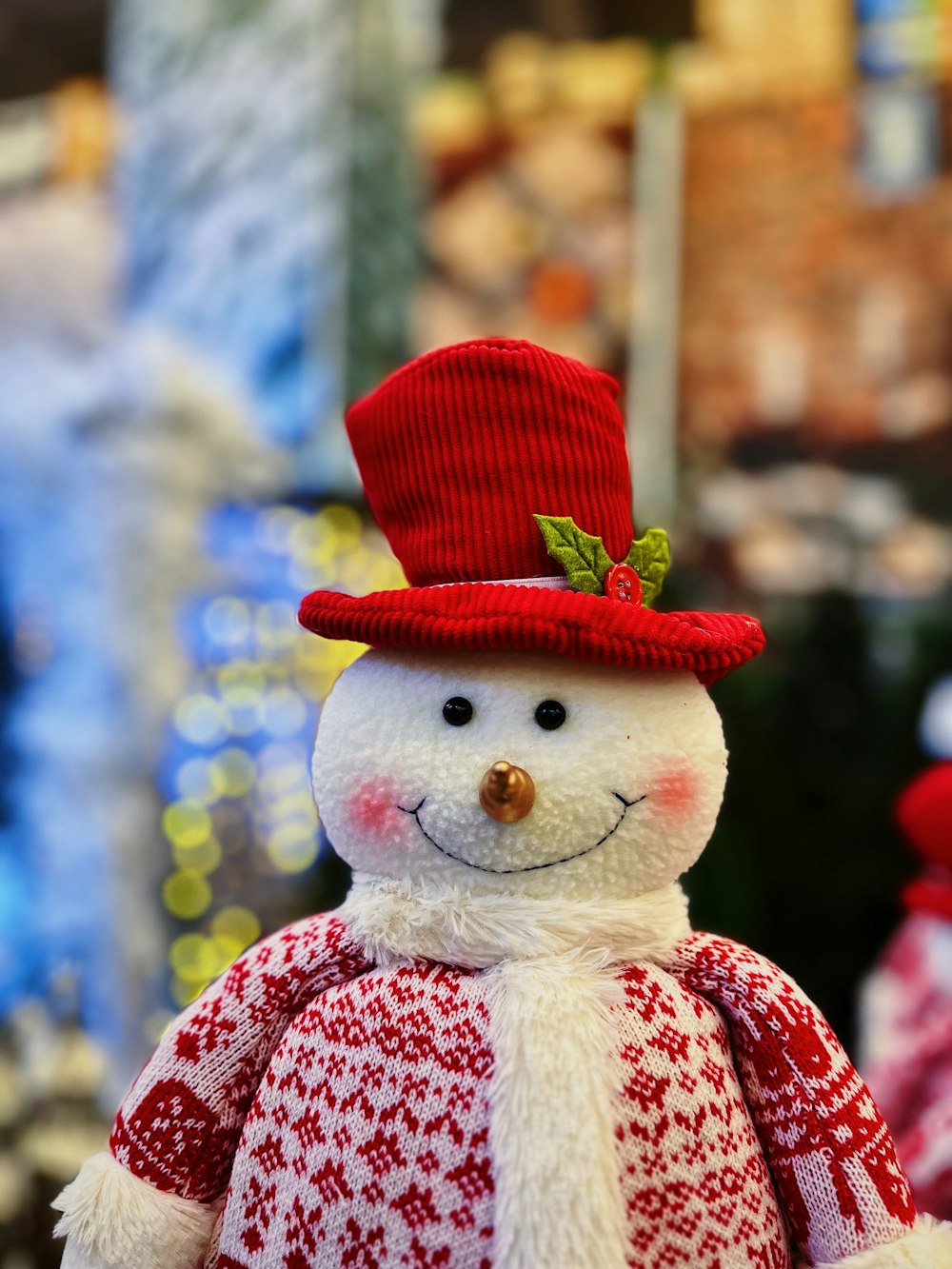 a snowman wearing a red hat and scarf