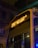 A city bus is seen at night with its LED display showing the route number 37A. The bus is parked in a dimly lit urban environment, visible against the backdrop of old architectural buildings. Streetlights create a warm glow, casting reflections off the wet surfaces of the bus from recent rain.