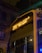A city bus is seen at night with its LED display showing the route number 37A. The bus is parked in a dimly lit urban environment, visible against the backdrop of old architectural buildings. Streetlights create a warm glow, casting reflections off the wet surfaces of the bus from recent rain.