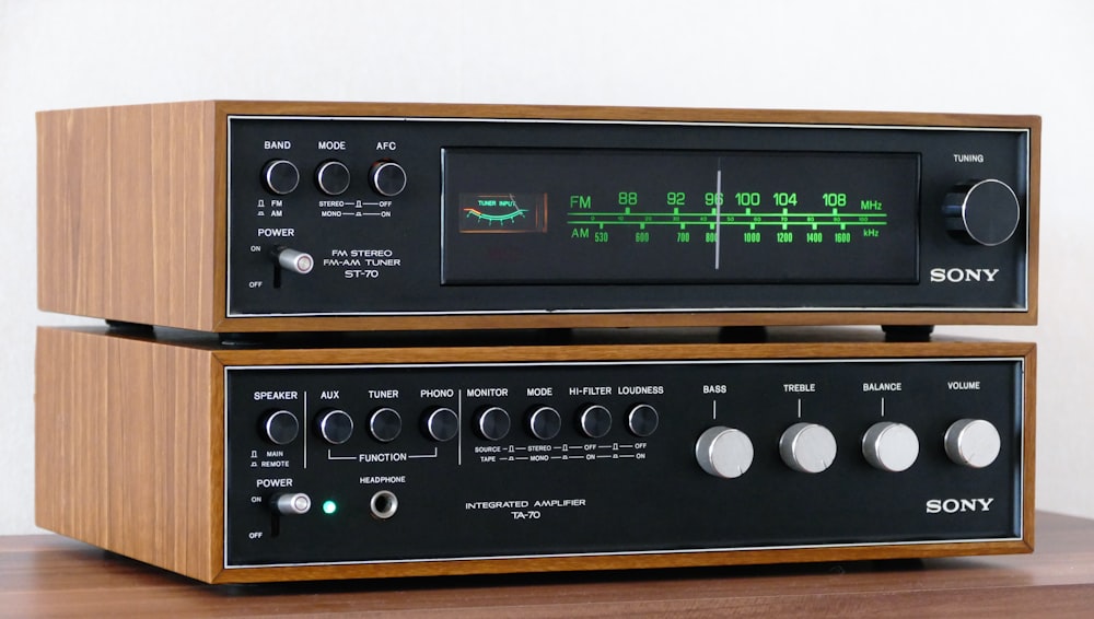 a pair of stereo equipment sitting on top of a wooden table