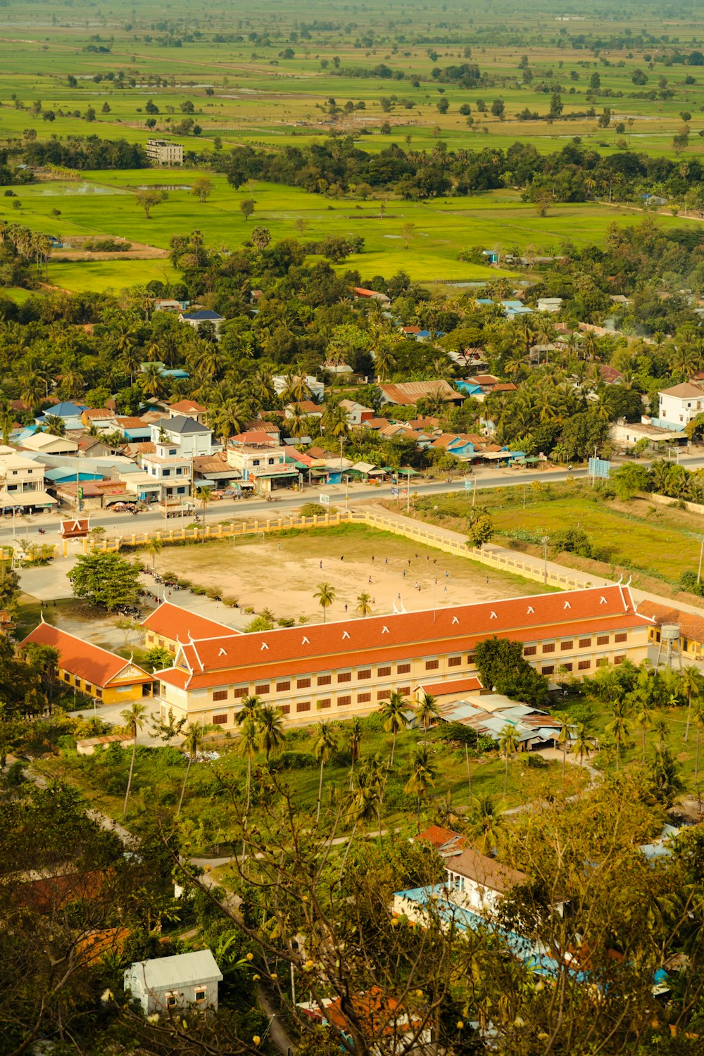 an aerial view of a large building surrounded by trees