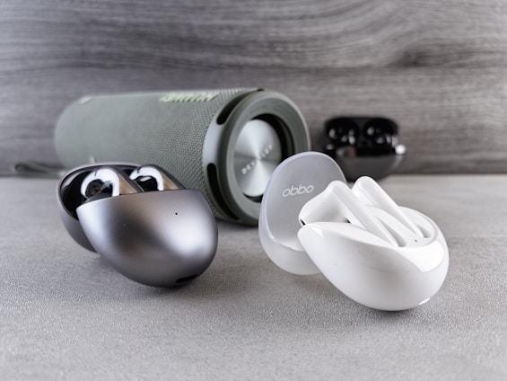 A variety of wireless headphones displayed on a table.