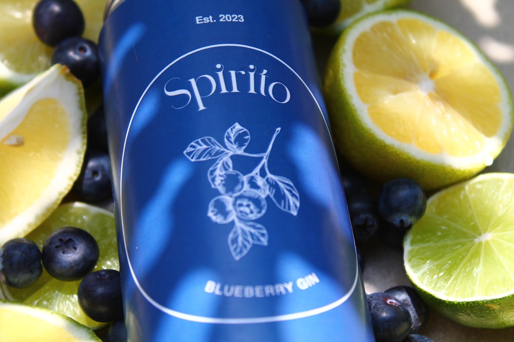 a bottle of spirito blueberry gin surrounded by lemons and blueberries