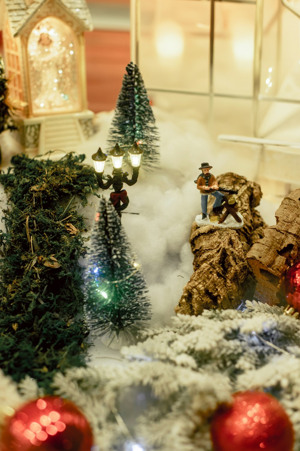 a display of christmas trees and decorations in a store window