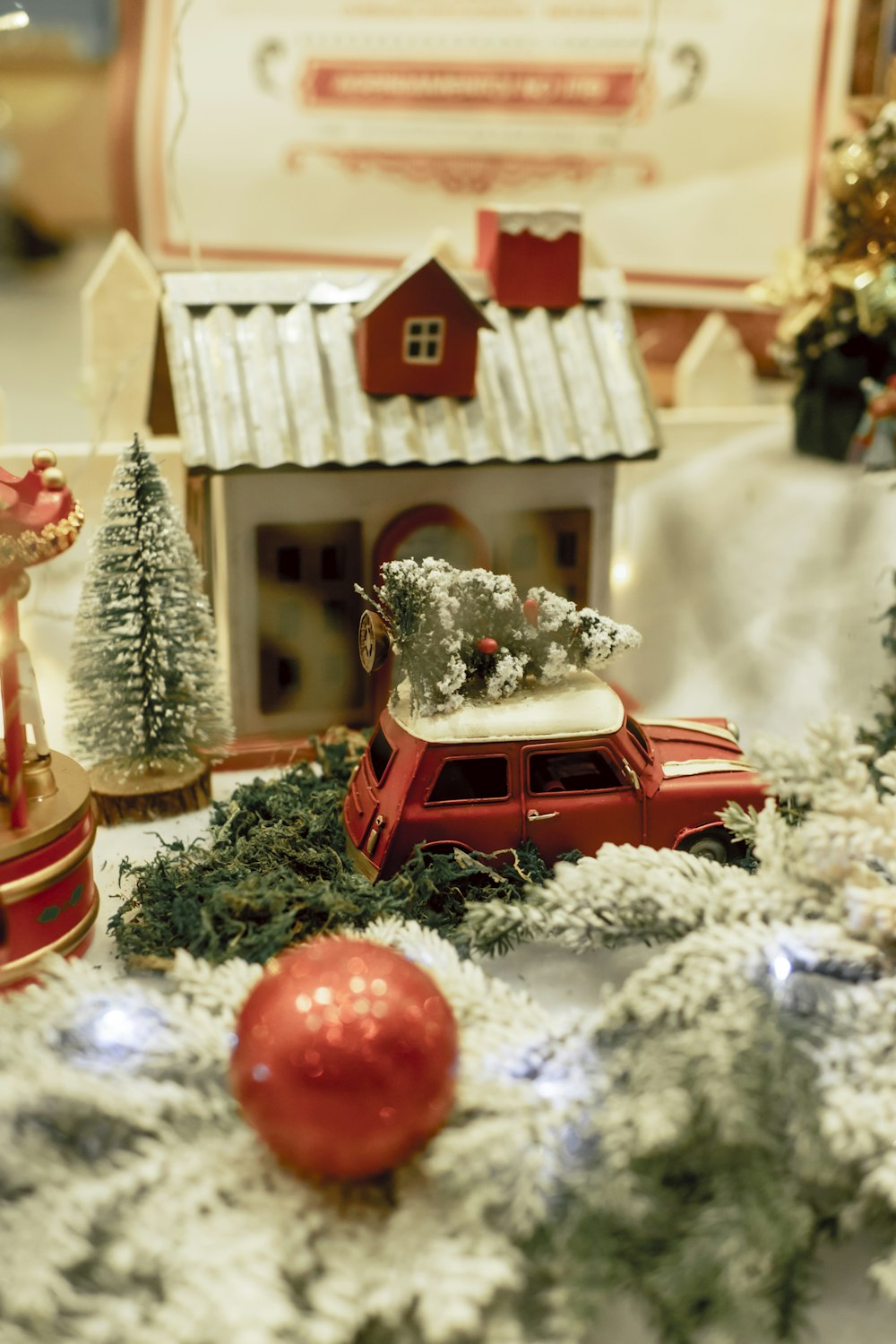 a christmas scene with a toy car and a house