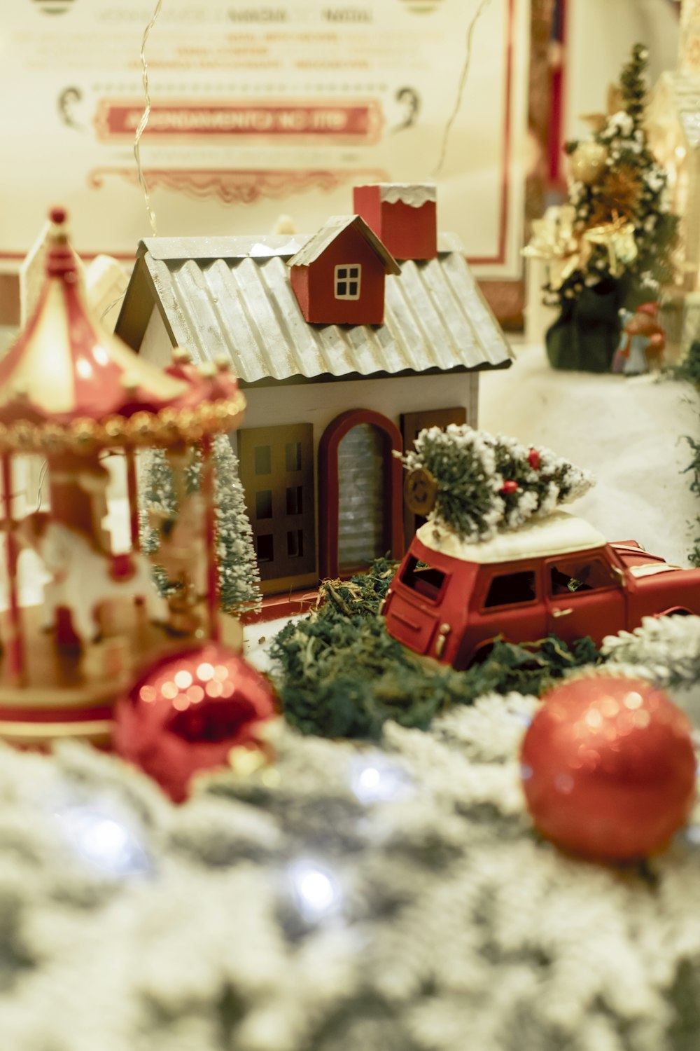 a christmas scene with a toy car and a house