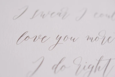 Elegant gold script on navy background reading 'Becoming Loved' surrounded by soft cream accents.