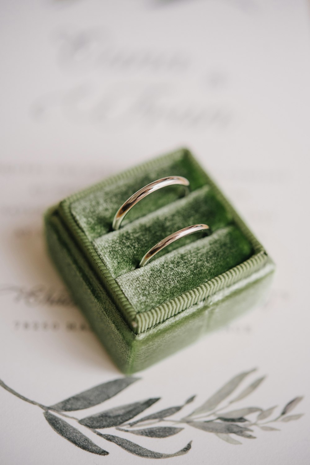 a couple of rings sitting on top of a green box