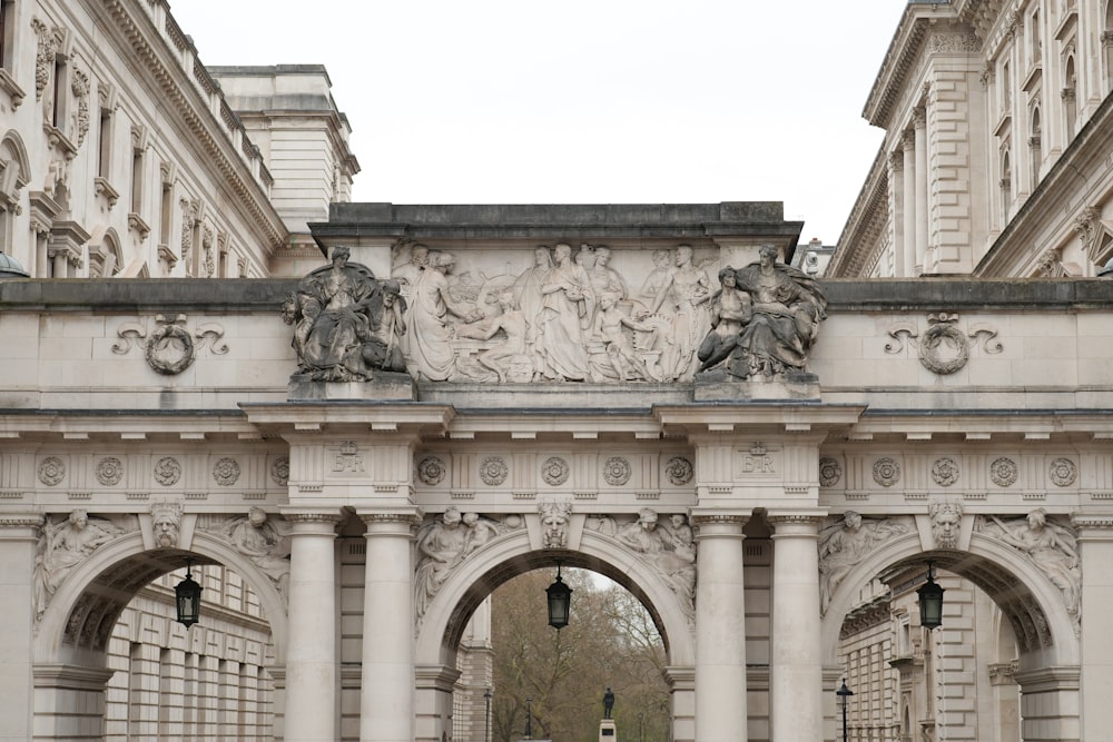 a large stone arch with statues on it