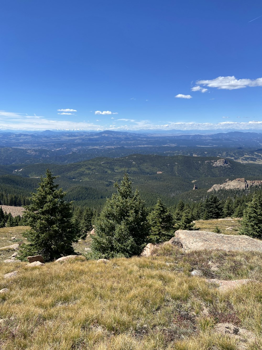 a view of the mountains from a hill top