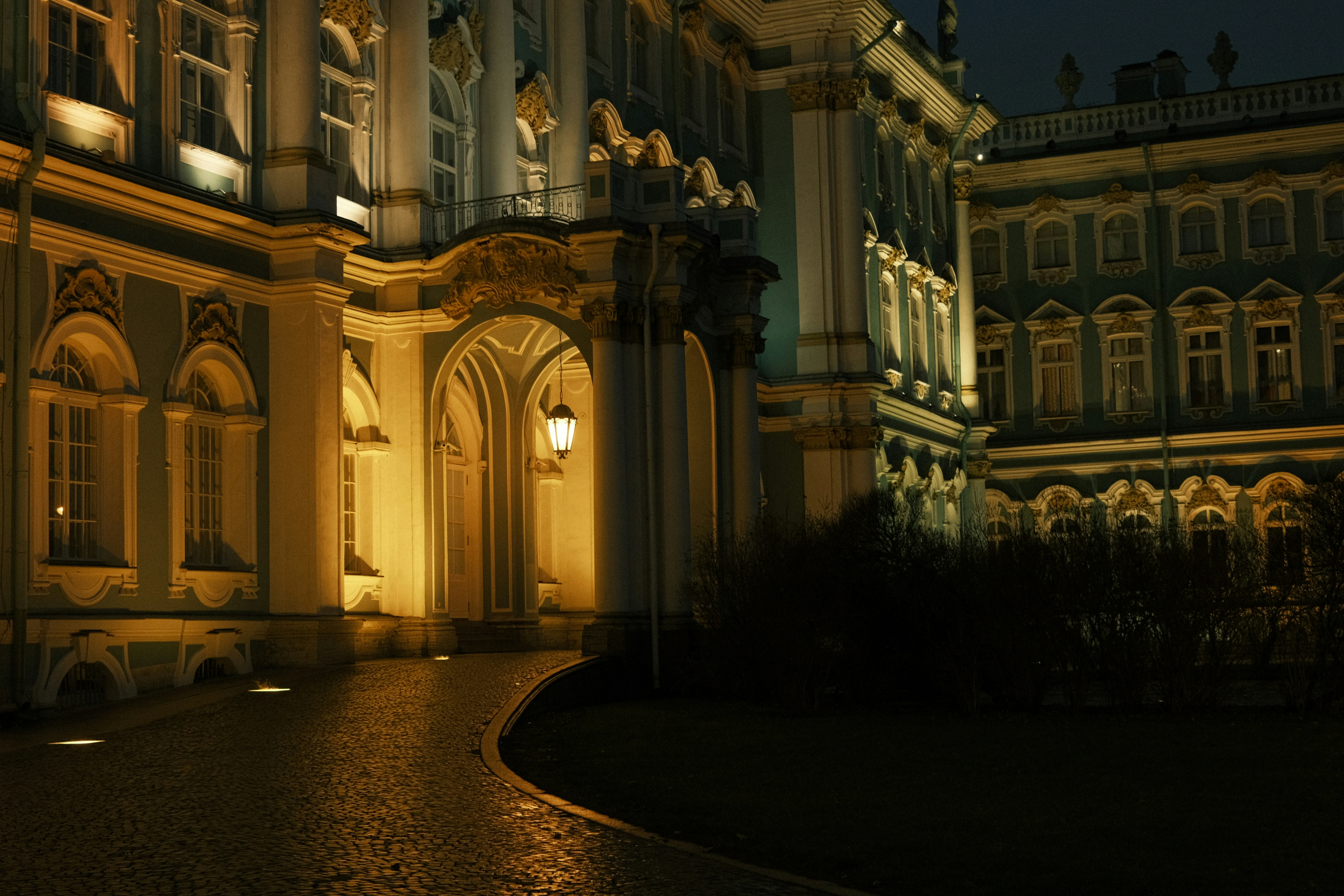 a building lit up at night with lights on