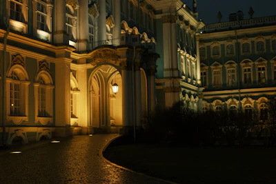 Elegant exterior facade illuminated with subtle lights highlighting stone and wood textures at night.