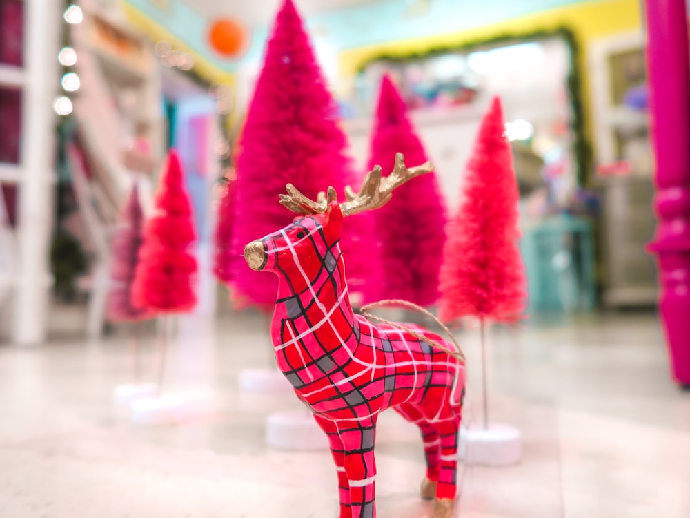 a red and black reindeer figurine in a store
