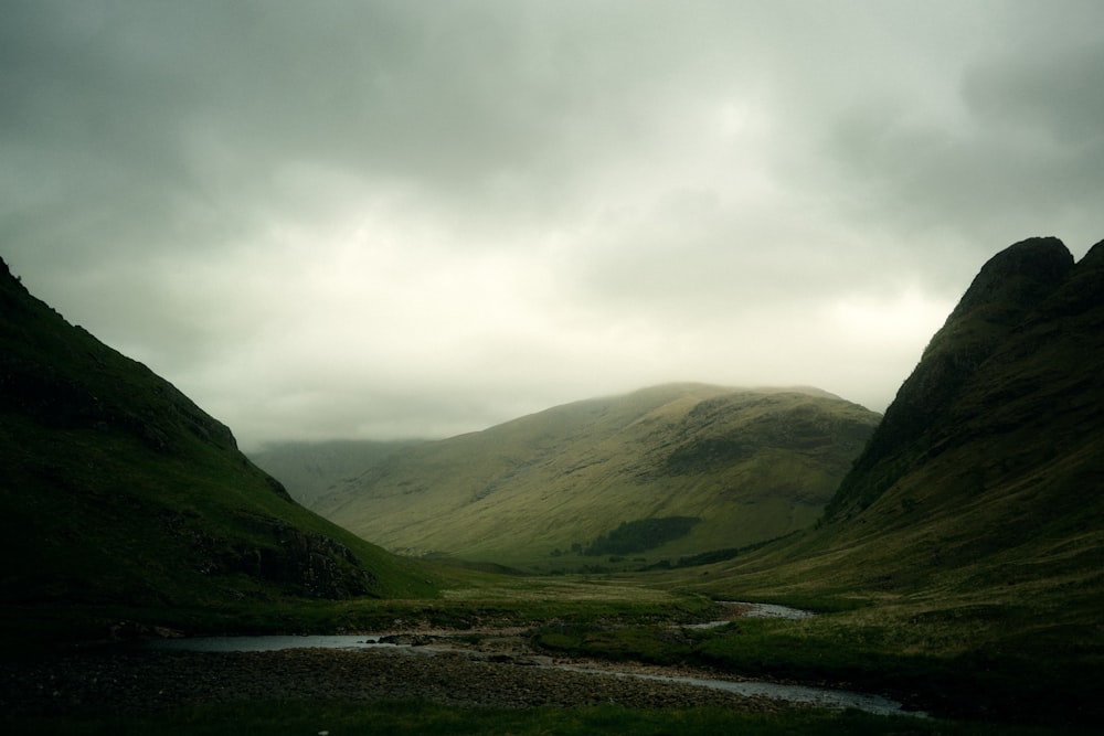 a river running through a lush green valley