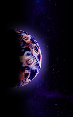 A celestial body with swirling, abstract patterns of vivid colors is partially illuminated against a deep space backdrop filled with faint stars and cosmic dust. The planet's surface features swirling patterns in shades of blue, red, and white, suggesting a gaseous or icy exterior.