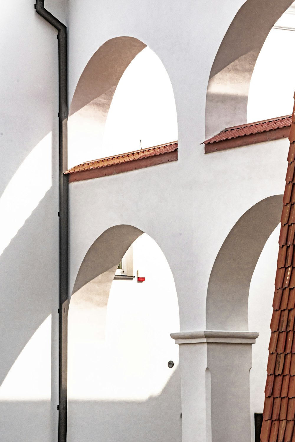 a white building with arches and a clock