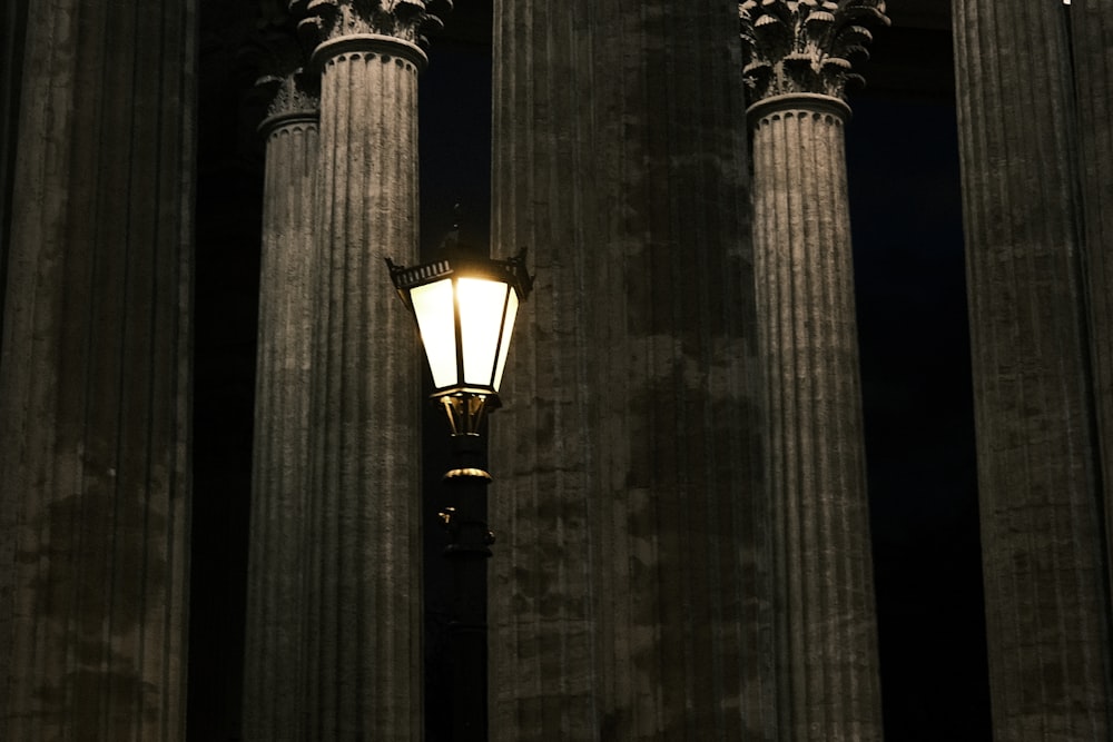 a street light sitting between two tall pillars