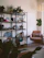 A cozy living room corner featuring a modern industrial-style dark wood and metal shelf.