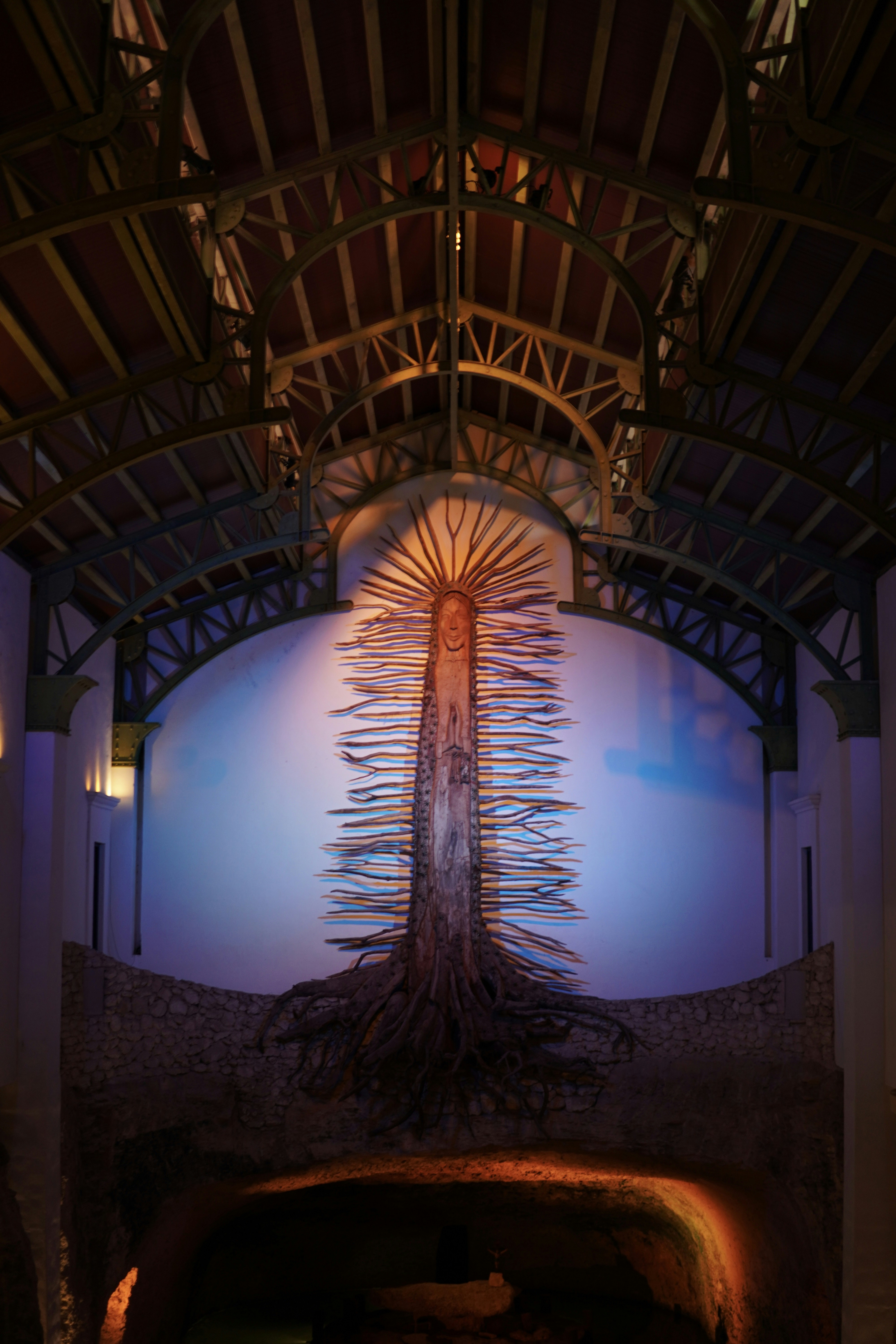 a very tall building with a very tall tree on it's side