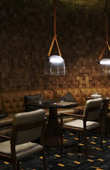 Cozy restaurant interior with elegant dark tones and a family enjoying a meal together.