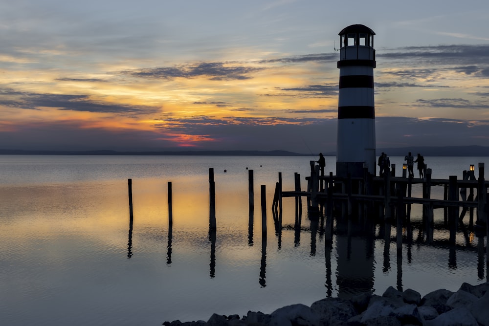 a light house sitting on top of a body of water