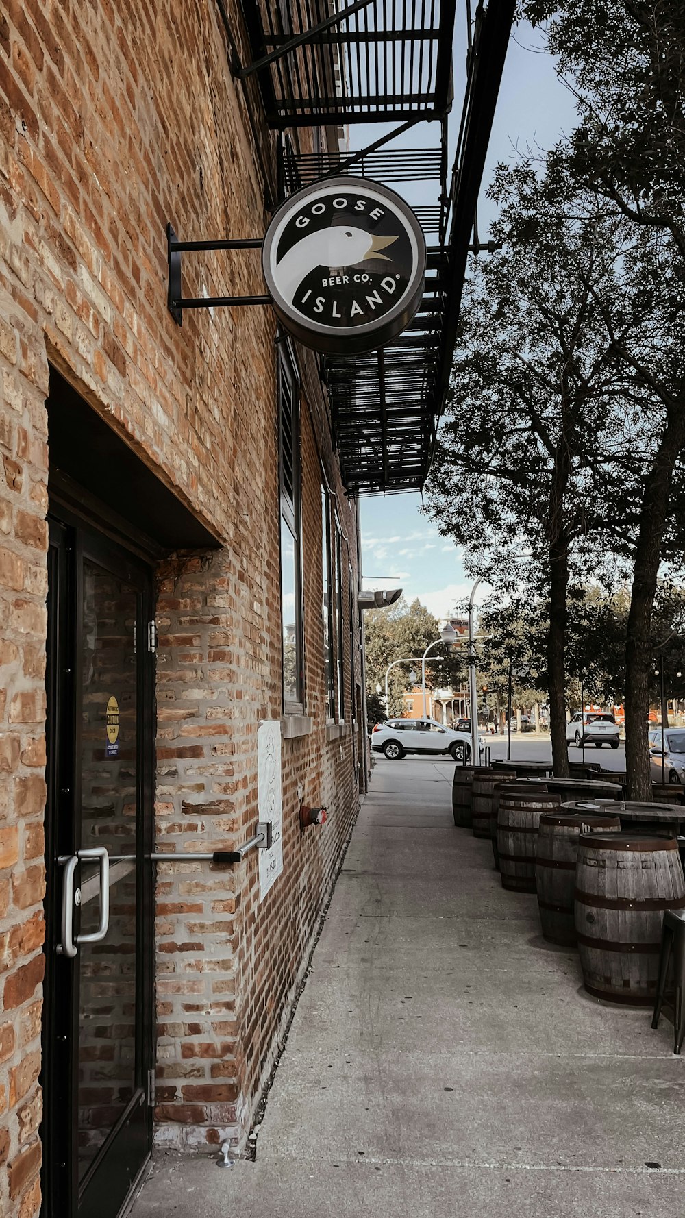 a brick building with a sign hanging from it's side