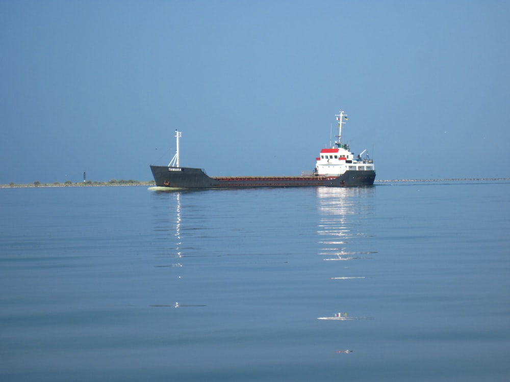 a large boat floating on top of a large body of water
