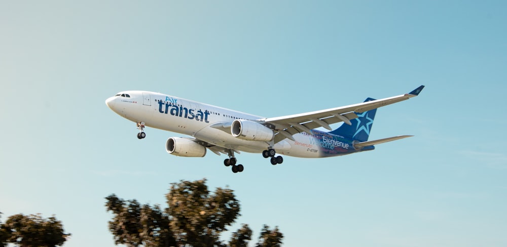 a large jetliner flying through a blue sky