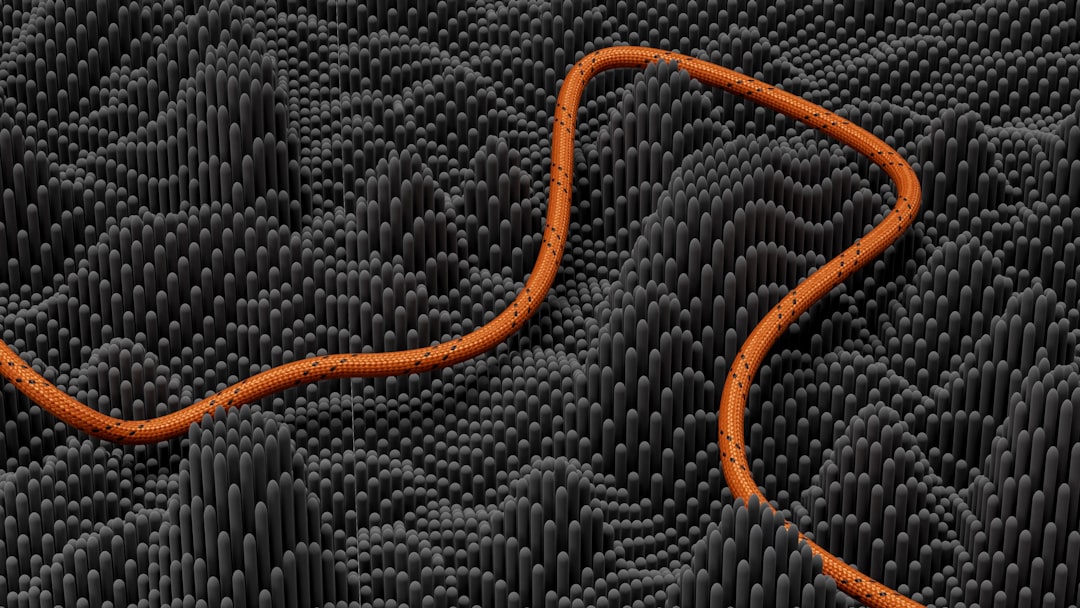 an orange snake is on a black background, A cable on a bar chart dark gray texture