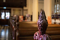 Close-up of the intricately carved wooden pews inside Bramham Sanctum, showing centuries of wear.