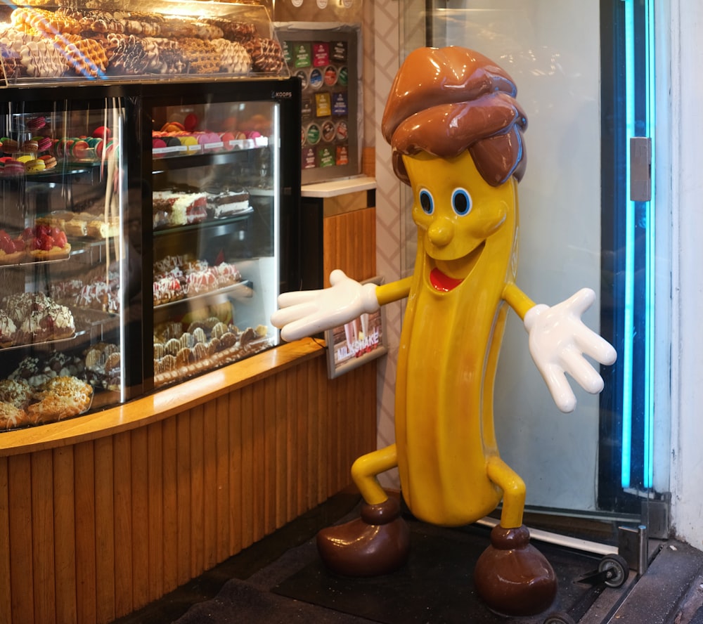 a large banana character standing in front of a bakery