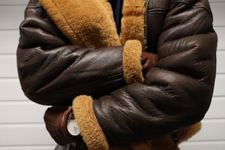 a close up of a person wearing a brown jacket