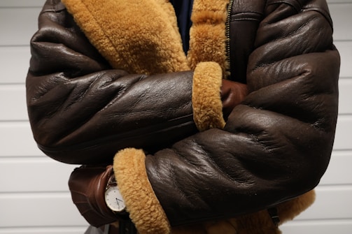 a close up of a person wearing a brown jacket